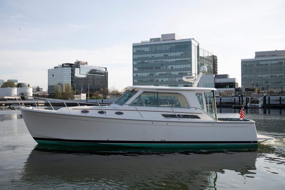 2014 Back Cove 37 Downeast yacht Happy Hour cruising on the water with a city skyline backdrop