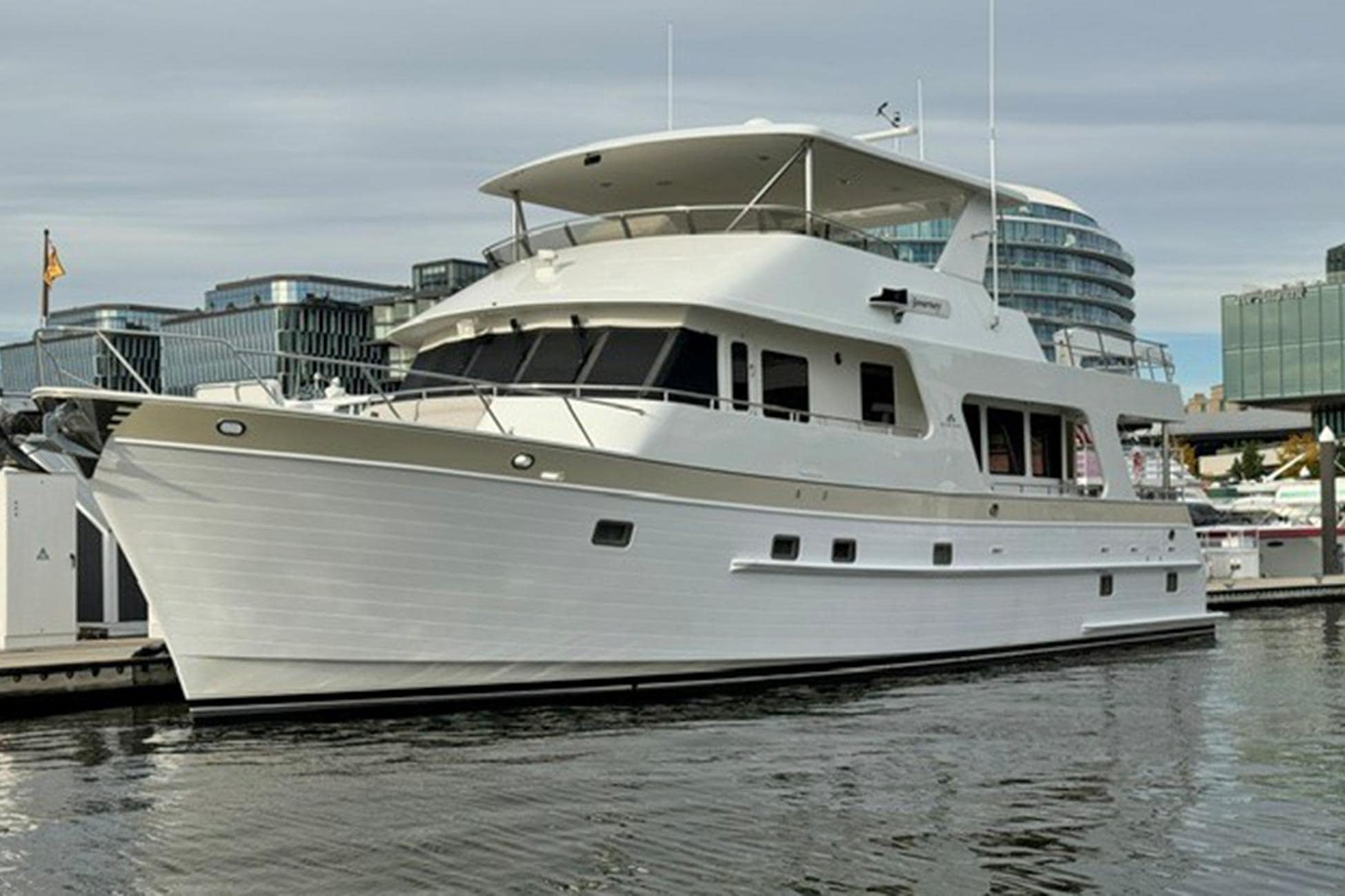 2008 Outer Reef 650 Motoryacht Journey cruising on the water, showing its profile view and classic raised pilothouse design