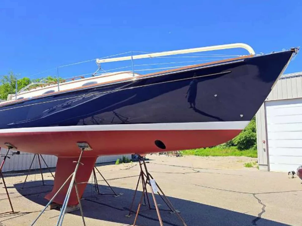 Bow profile of the Alerion 41 electric sailboat for sale, highlighting the Flag Blue hull, clean bottom paint, and bow thruster.