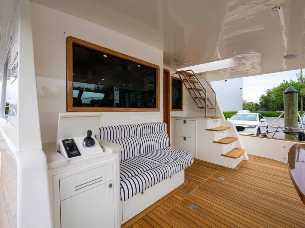 Teak side deck walkway on the Grand Banks 60 yacht with the chrome GB logo on the cabin wall