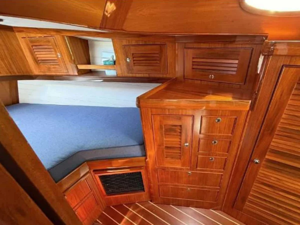 Built-in cherry wood hanging locker and storage drawers in the forward stateroom of the Alerion 41 sailboat.
