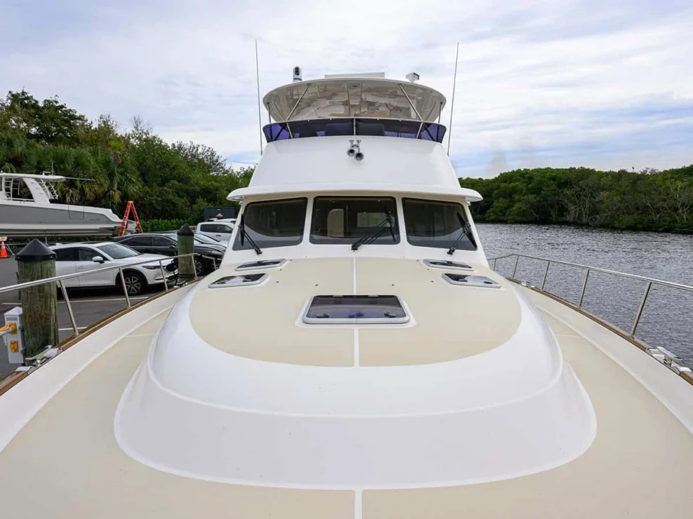 Port side cockpit on the Grand Banks 60 with a striped bench seat, joystick station, and bridge steps