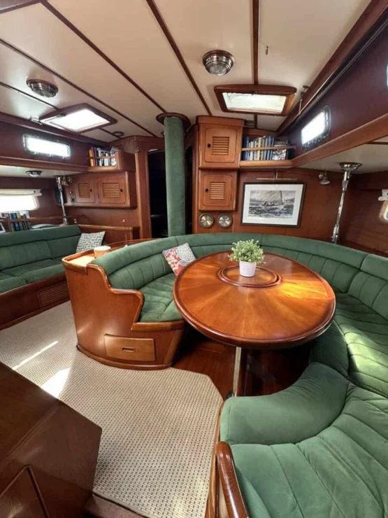 Little Harbor 53 view of main salon with curved settee and table.