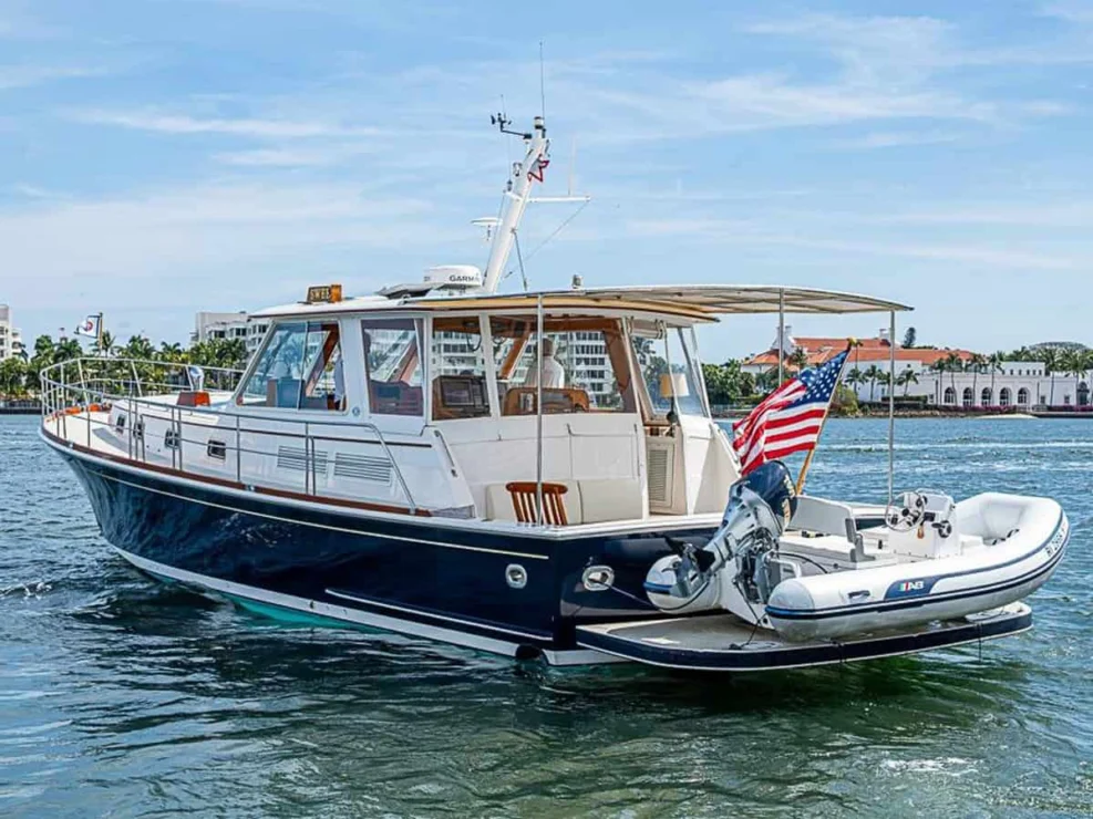 2001 Grand Banks Eastbay 46 Sweet aft port quarter in the water with tender on swim platform.