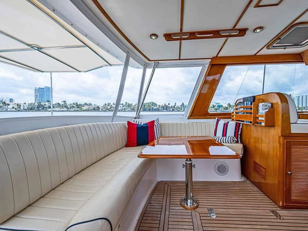 2001 Grand Banks Eastbay 46 Sweet large L-settee with table to port behind companion seat in pilothouse.