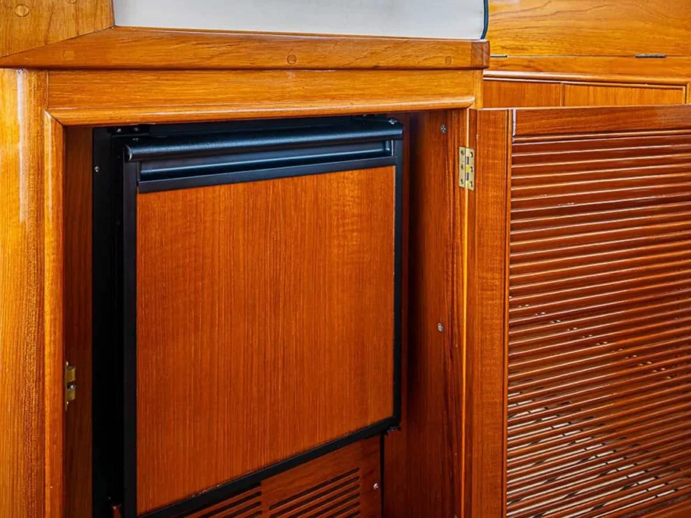 2001 Grand Banks Eastbay 46 Sweet pilothouse refrigerator under companion helm seat.