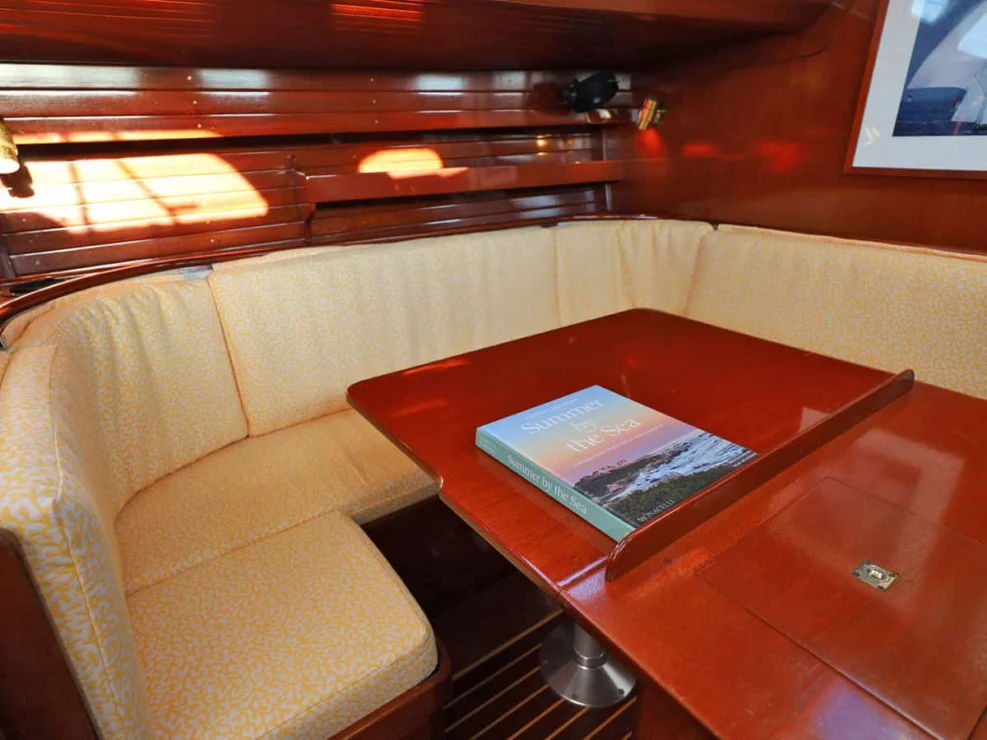 Image of MOONLIGHT, 1980 Hinckley Bermuda 40 MKII, view of settee and table in port salon.