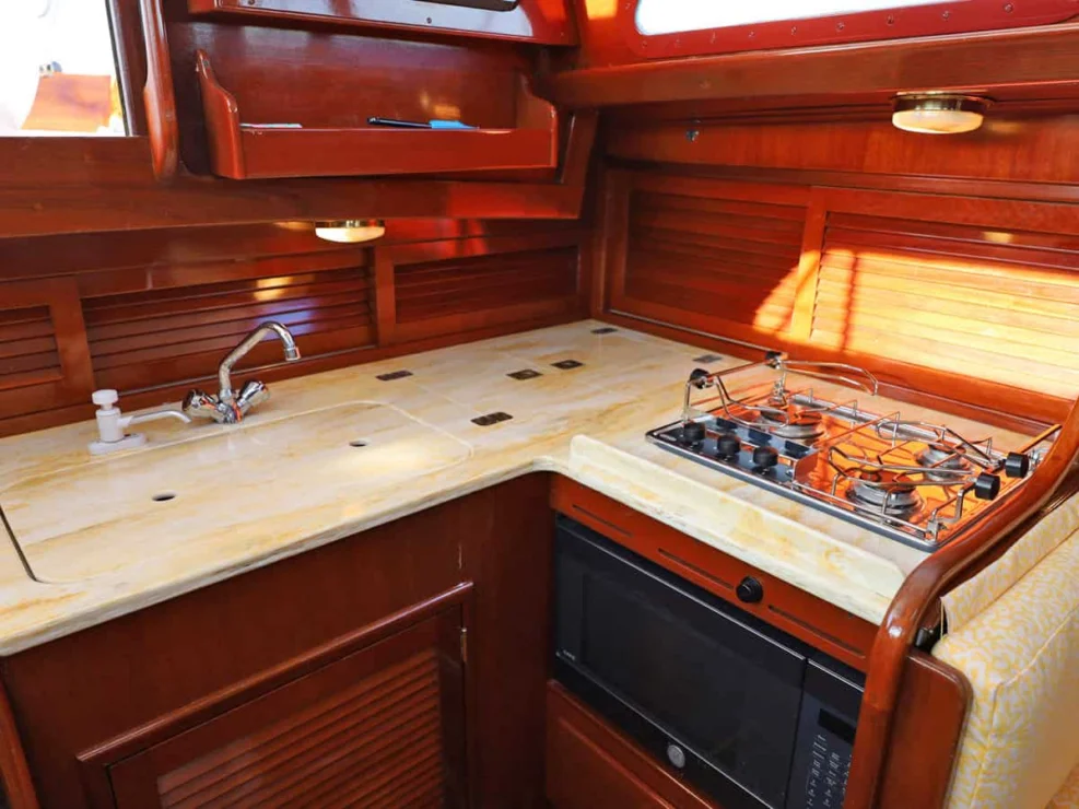 Image of MOONLIGHT, 1980 Hinckley Bermuda 40 MKII, view of galley details with stove, microwave and countertops.