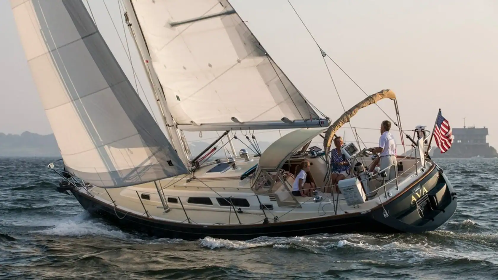 Sabre 386 sailing yacht stern quarter view sailing on the ocean.