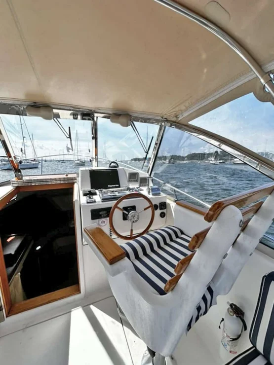 2000 Legacy 28 Express helm seat to starboard.