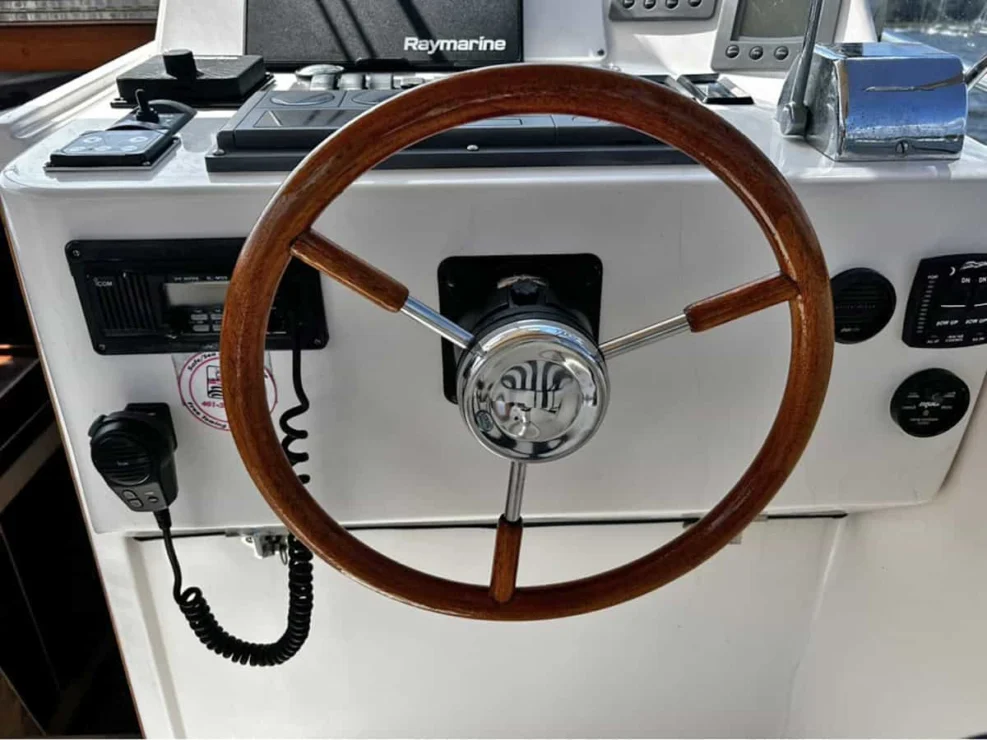2000 Legacy 28 Express steering wheel at helm station.