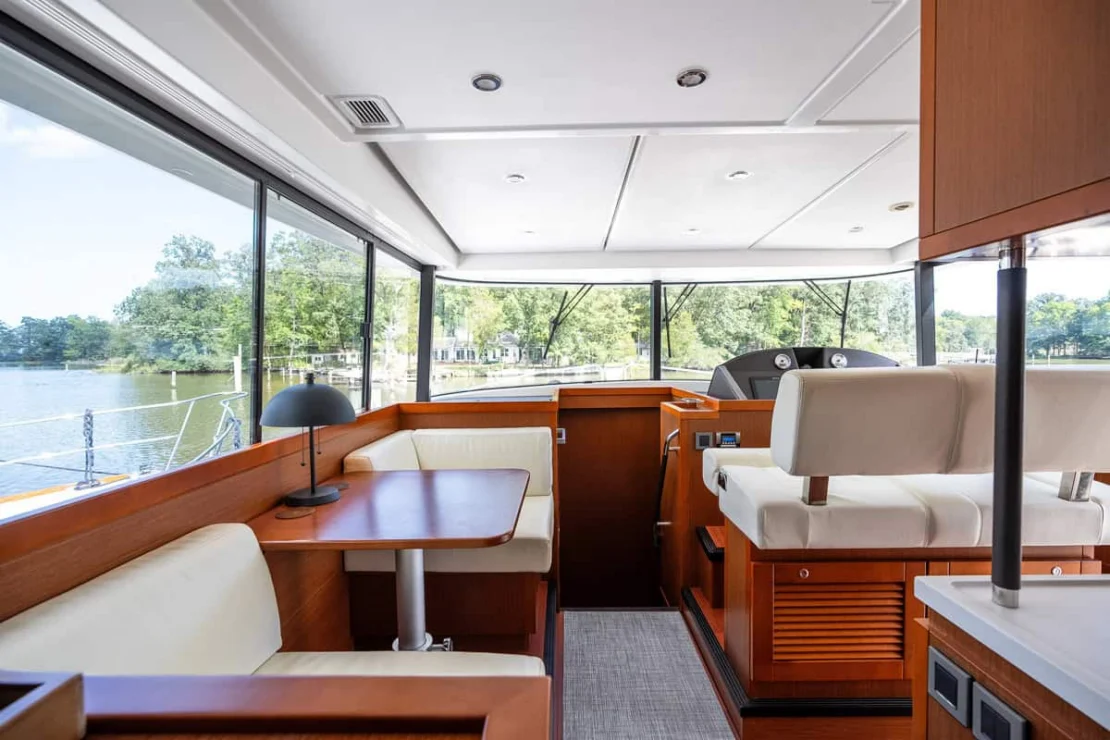 Beneteau Oceanis Swift Trawler 50 pilothouse forward with settee and helm station.