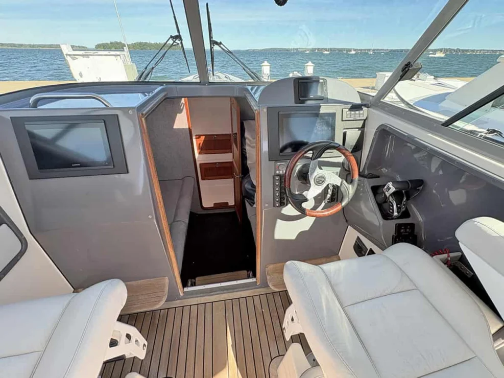 2011 Protector Tauranga 41 helm with steering wheel and Garmin displays.