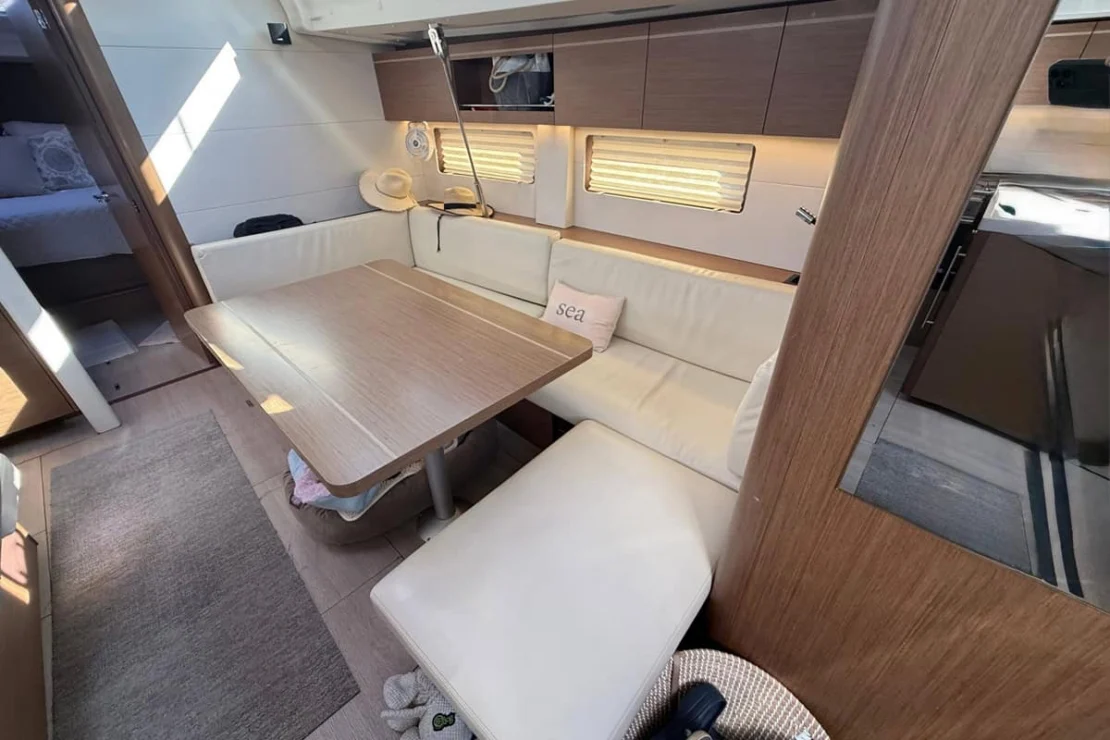 Beneteau Oceanis 51, salon settee with table.